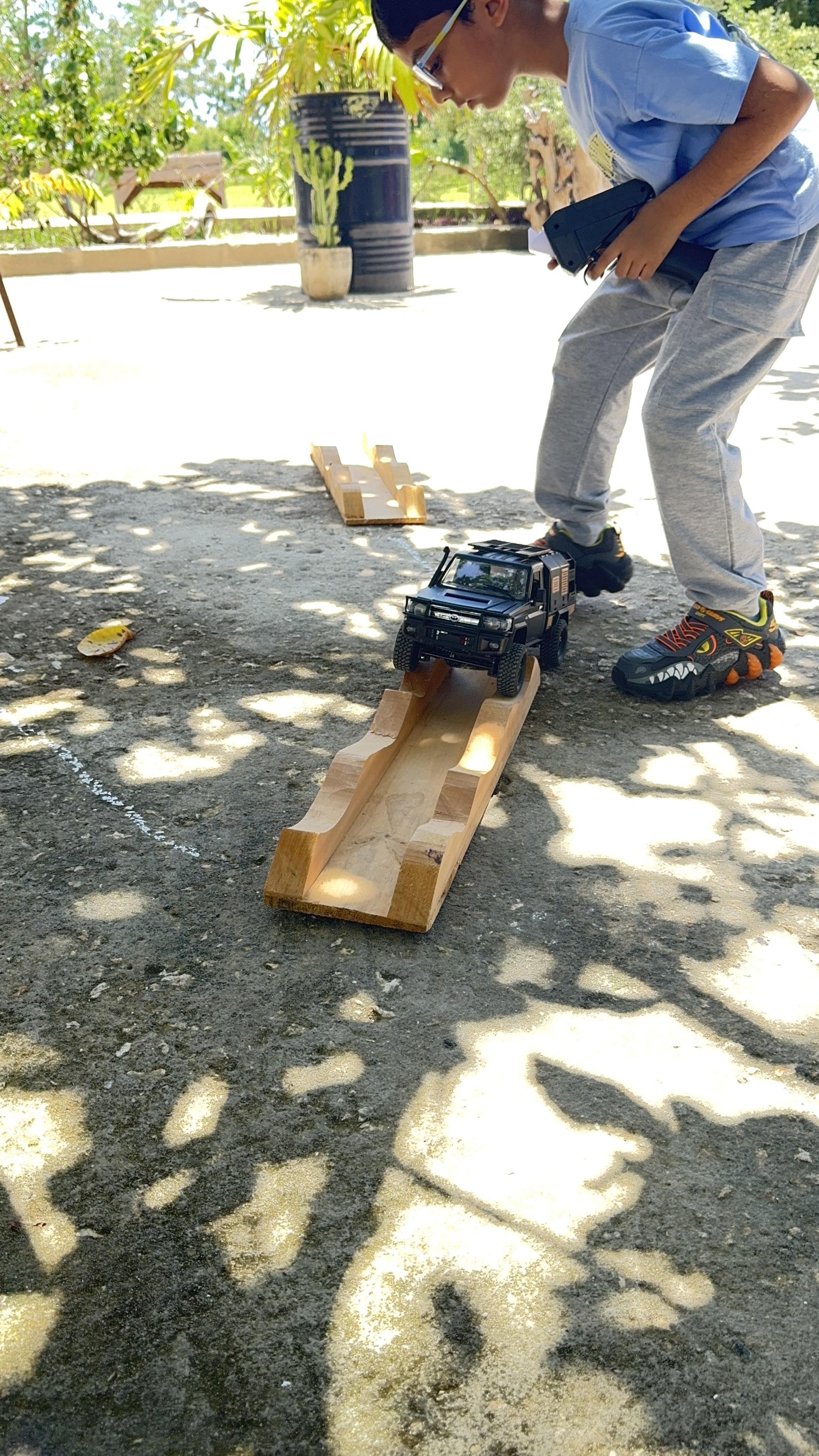 A young driver steering through a Bongo RC skills course